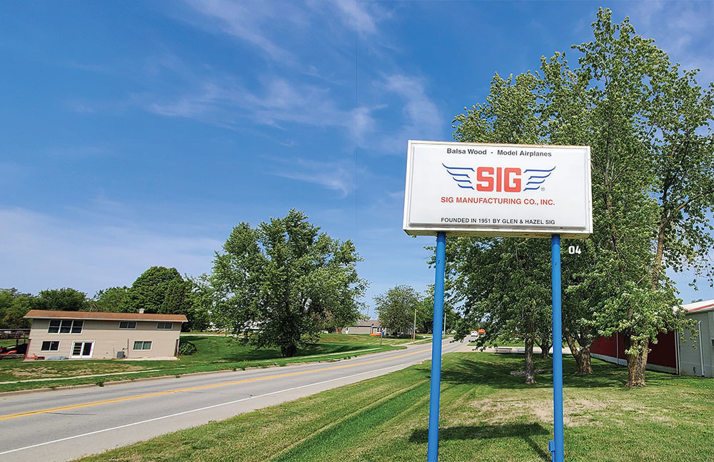 The Sig Manufacturing Co. headquarters sign sits across the street from Hazel’s childhood home in Montezuma, Iowa.